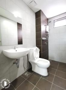 Iskandar PuteriにあるKiddo Best Stayの白いトイレと洗面台のあるバスルーム