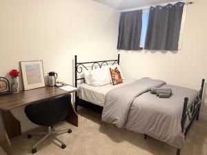 a bedroom with a desk and a bed and a desk at LuxSpaces Ventures in London