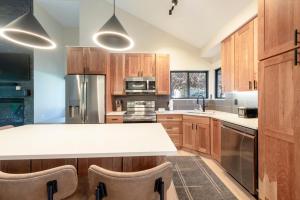 een keuken met houten kasten en een wit aanrecht bij Hidden Creek 37D condo in Park West Ski Area Heliport