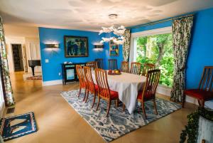 a dining room with blue walls and a table and chairs at The Cottage at Seaside in Friendship in Friendship