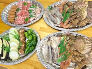 a group of plates of seafood on a table at 三陸アクティブ in Ōfunato +12 photos