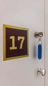a door with a key and a sign with the number at Hotel Kapsul Vlore in Vlorë