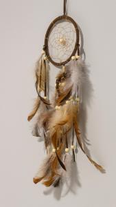 a dream catcher with feathers hanging on a wall at Hotel Kapsul Vlore in Vlorë