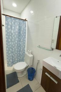 um banheiro com vaso sanitário e cortina de chuveiro em Cabana da Mari em Fernando de Noronha