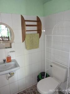 a bathroom with a toilet and a sink at Beach & forest Escape in Santo Domingo +14 photos