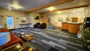 a living room with a couch and a stair case at Laurie's Inn in Chéticamp