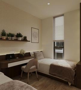 a bedroom with two beds and a desk with a laptop at The Kind Villas Phu Quoc in Phu Quoc
