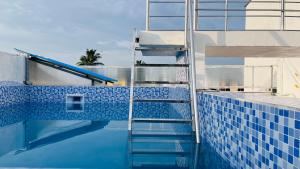 a blue tile swimming pool with a ladder in the water at The Chalet - Cozy Villa with Mini Pool, near Eden Blue Flag Beach, Pondicherry - BMC in Pondicherry