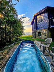 a pool of water in front of a house at Iconic Chalet with Sauna, Hot Tub, Fire Pit, Plunge in Harpers Ferry