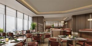 a restaurant with tables and chairs and large windows at Hilton Garden Inn Jingzhou Shashi in Jingzhou