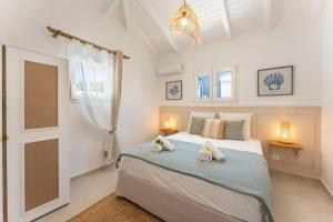 a bedroom with a bed with two towels on it at Villa Azura - Accès mer & piscine privée in Le Moule +19 photos