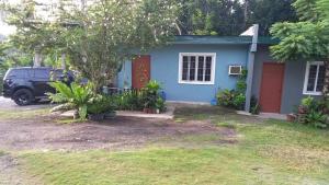 a blue house with a car parked in front of it at BOHOL Simple and Elegant Furnished Studio in Tagbilaran City