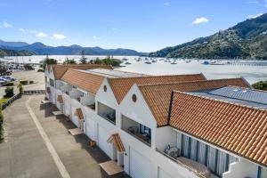 a row of buildings with a view of the water at Marina Edge Marlborough Sounds Apartment in Waikawa