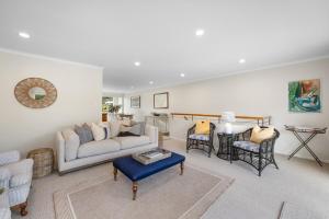 a living room with a couch and chairs at Marina Edge Marlborough Sounds Apartment in Waikawa