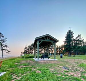 a picnic shelter in a park next to the water at Bonavista Hideaway in Stratford