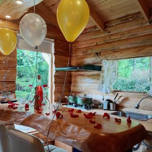 a table with balloons and roses on it in a kitchen at Chalet el Pinar in La Calera