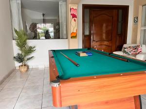 a pool table sitting in a living room with at Casa Baraquel in Arequipa