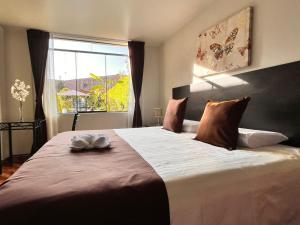 a bedroom with a large bed with a large window at Casa Baraquel in Arequipa +90 photos