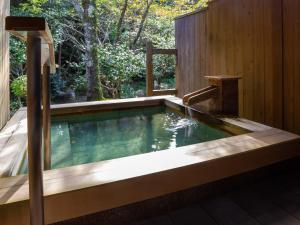 a pool in a backyard with a wooden fence at Tsukiyominoza in Ise