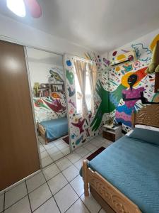 a bedroom with a bed in a room with colorful walls at CASA de TEMPORADA para COP 30 in Belém