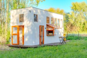 a tiny house in the middle of a field at Refugio Campestre, Cabaña con Tinaja Opcional 
