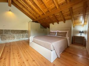 Un dormitorio con una cama y suelo de madera. en Quinta de Cartas,  86 fotos más