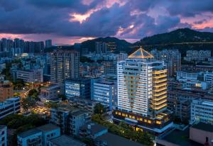 a view of a city at night at Days Inn by Wyndham Zhuhai Qinglv Road in Zhuhai
