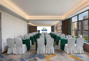 a conference room with green and white chairs and tables at Days Inn by Wyndham Changsha Yuanda Road in Changsha