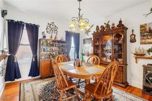 a dining room with a wooden table and chairs at The Boulevard Stay in Cleveland