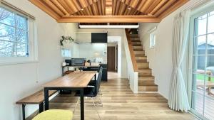 a dining room with a wooden table and chairs at Solana伊豆高原 in Futo +27 photos