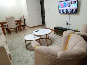 a living room with two chairs and a table at One Bedroom Executive Stays In Eldoret in Eldoret