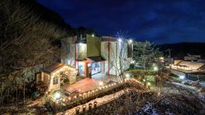 a house lit up at night with lights at Gapyeong Rubino Pension in Gapyeong
