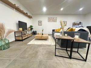 a living room with a couch and a tv at App 4-6 Pers - Terrasse - Calme - Reposant in La Chambre