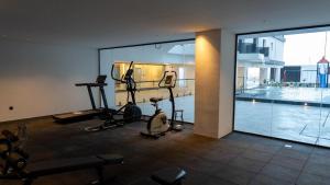 a gym with several exercise bikes and a swimming pool at Sohob Compound in Al Khobar