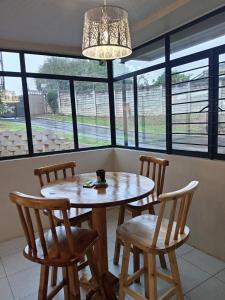 a table and chairs in a room with windows at The Deyzel house in Durban