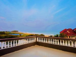 a balcony with a view of the ocean at BERG'S BEACH HOUSE in Winneba
