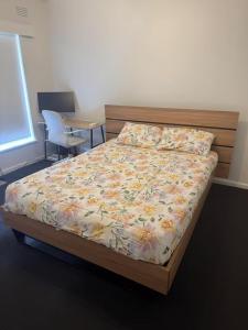 a bedroom with a bed and a table and chairs at Spacious Room in Ivanhoe, Melbourne in Melbourne