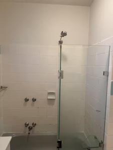 a bathroom with a shower and a bath tub at Spacious Room in Ivanhoe, Melbourne in Melbourne
