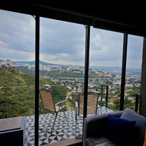 a living room with a view of a city at Brick Box Loft con Balcon in Hércules