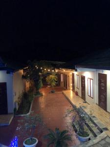 a courtyard of a house at night with lights at Trúc Linh Homestay in Làng Môn