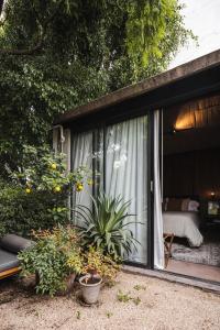 a house with a window with a bed in it at Aposento Boutique Hotel in Mexico City +26 photos