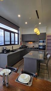 a kitchen with a wooden table and a counter top at The Grand in Suva