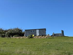 a house sitting on top of a grass field at The Shepherd's Rest in Oamaru +20 photos