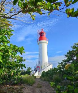 a lighthouse with a red and white lighthouse at La BEL KREOL in Le Gosier +3 photos