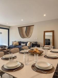 a living room with a table and a couch at Luxury Retreat in Puerto Cancun with Rooftop Pool in Cancún