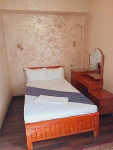 a bedroom with a bed and a dresser and a mirror at Ak zhol in Almaty