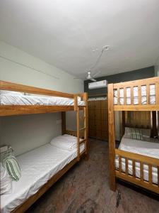 two bunk beds in a small room with at Journey junction backpackers hostel in Tiruchchirāppalli
