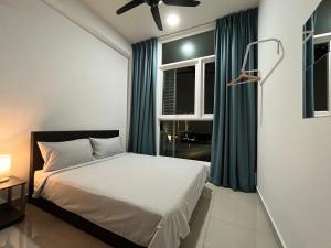 a bedroom with a bed and a window with green curtains at Goldenstay Mutiara Ville Cyberjaya in Cyberjaya +35 photos