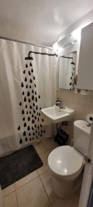 a bathroom with a white toilet and a sink at Medium size room for 2 in Toronto +15 photos
