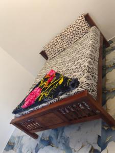 a bed with two pillows on top of it at Nakshatra Homestay in Vattavada